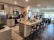Open-concept kitchen with granite island, stainless appliances, and a breakfast bar at 1905 Blue Stream St, Ruskin, FL 33570