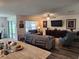 Open living room with a large TV, comfortable seating, and access to a patio at 1905 Blue Stream St, Ruskin, FL 33570