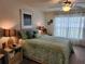 Bedroom with ceiling fan, neutral walls, and natural light from a large window at 1905 Blue Stream St, Ruskin, FL 33570