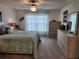 Well-lit bedroom featuring a comfortable bed and neutral décor with a light wood dresser at 1905 Blue Stream St, Ruskin, FL 33570