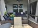 Enclosed patio has ceiling fan and outdoor sectional with decorative pillows at 1905 Blue Stream St, Ruskin, FL 33570