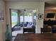 View from dining area out to enclosed patio with outdoor seating and decor at 1905 Blue Stream St, Ruskin, FL 33570