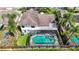 Aerial view of home showcasing a screened-in pool, with spa, and spacious yard at 1906 White Cedar Way, Brandon, FL 33511