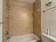 Bathroom features a tiled shower and tub combination with updated fixtures at 1906 White Cedar Way, Brandon, FL 33511