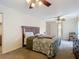 Spacious bedroom featuring a ceiling fan, a wooden headboard bed frame and natural light from a window at 1906 White Cedar Way, Brandon, FL 33511