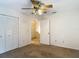 Bedroom with neutral carpeting, ceiling fan, and closet, with a door leading to the hallway at 1906 White Cedar Way, Brandon, FL 33511