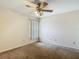 Cozy bedroom featuring neutral carpeting, a ceiling fan and a window at 1906 White Cedar Way, Brandon, FL 33511