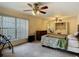 Bedroom features ceiling fans, a large window, and a washer and dryer in an open closet at 1906 White Cedar Way, Brandon, FL 33511