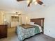 This bedroom includes a washer and dryer, ceiling fans, and a view of the en suite bathroom at 1906 White Cedar Way, Brandon, FL 33511