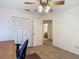 Carpeted bedroom with ceiling fan, closet, and office chair at 1906 White Cedar Way, Brandon, FL 33511