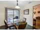 Cozy dining area with a glass table, four chairs, and sliding doors to the outside at 1906 White Cedar Way, Brandon, FL 33511