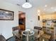 Dining room features a glass table with seating for four, and opens to the kitchen for easy serving at 1906 White Cedar Way, Brandon, FL 33511