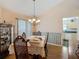 Formal dining area with wood floors, chandelier, large window and a built-in hutch at 1906 White Cedar Way, Brandon, FL 33511