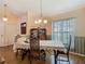 Dining room with wood flooring, chandelier, and a window overlooking the outdoor landscape at 1906 White Cedar Way, Brandon, FL 33511