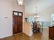 Entryway with hardwood floors that lead into a dining area that features a chandelier and lots of natural light at 1906 White Cedar Way, Brandon, FL 33511