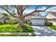 Charming single-story home with well-maintained landscaping, mature tree, and a two-car garage at 1906 White Cedar Way, Brandon, FL 33511