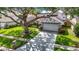 Charming single-Gathering home with mature shade tree, lush lawn, and a two-car garage at 1906 White Cedar Way, Brandon, FL 33511