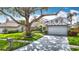 Charming home with mature landscaping, lush lawn, two-car garage, and stone accents at 1906 White Cedar Way, Brandon, FL 33511