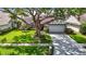 Charming single-Gathering home with large shade tree, lush lawn, and a two-car garage at 1906 White Cedar Way, Brandon, FL 33511