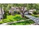 Lovely single-story home featuring a lush lawn, mature tree, and a driveway leading to the garage at 1906 White Cedar Way, Brandon, FL 33511