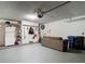 Spacious garage with ample storage, refrigerator, seating and supplies at 1906 White Cedar Way, Brandon, FL 33511