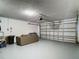 Spacious garage with gray painted floor; ample room for parking and storage with an automatic door opener at 1906 White Cedar Way, Brandon, FL 33511