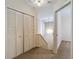 Hallway with closet and view into a bedroom that has carpet floors at 1906 White Cedar Way, Brandon, FL 33511