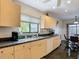 Kitchen featuring wooden cabinets, stainless steel sink, and an adjacent dining area at 1906 White Cedar Way, Brandon, FL 33511