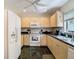 Functional kitchen with wooden cabinets, standard appliances, and a window with a view at 1906 White Cedar Way, Brandon, FL 33511