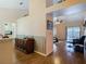 Open concept space with hardwood floors and view to the living room and screened in outdoor space at 1906 White Cedar Way, Brandon, FL 33511