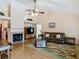 Inviting living room featuring a brick fireplace, ceiling fan, and sliding glass door at 1906 White Cedar Way, Brandon, FL 33511