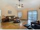 Inviting living room boasting high ceilings, a ceiling fan, and sliding glass doors to the pool at 1906 White Cedar Way, Brandon, FL 33511