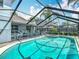Relaxing screened-in pool and spa area complete with comfortable seating at 1906 White Cedar Way, Brandon, FL 33511