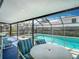 The screened-in pool and spa offer an outdoor space for relaxation and enjoyment with the surrounding landscape and seating at 1906 White Cedar Way, Brandon, FL 33511