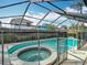 The pool and spa are enclosed in a screened cage; a safe and relaxing outdoor space at 1906 White Cedar Way, Brandon, FL 33511