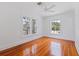 Empty bedroom with hardwood floors, white walls, and windows offering bright, natural light at 1920 Cherry Ne St, St Petersburg, FL 33704