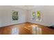 Bright bedroom with hardwood floors, ceiling fan, and sun-filled windows at 1920 Cherry Ne St, St Petersburg, FL 33704