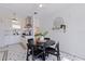 Charming breakfast nook features a dark round table, pendant lighting, and a view into the kitchen at 1920 Cherry Ne St, St Petersburg, FL 33704
