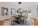 Bright dining room with a wooden table, modern chandelier, and ample natural light from large windows at 1920 Cherry Ne St, St Petersburg, FL 33704