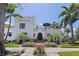 Charming two-story home featuring a barrel tile roof, green trim, and mature landscaping at 1920 Cherry Ne St, St Petersburg, FL 33704