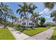 Expansive corner lot with lush landscaping, mature palms, and verdant lawn at 1920 Cherry Ne St, St Petersburg, FL 33704