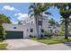 Two-story house showcasing a beautiful facade, a barrel tile roof, and an attached garage at 1920 Cherry Ne St, St Petersburg, FL 33704