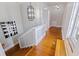 Hallway with hardwood floors and a decorative light fixture at the top of the stairs at 1920 Cherry Ne St, St Petersburg, FL 33704