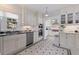 Bright kitchen featuring white cabinets, stainless steel appliances, black and white tiled floor, and granite countertops at 1920 Cherry Ne St, St Petersburg, FL 33704
