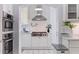 Close up of a kitchen featuring stainless steel appliances, tiled backsplash and unique black and white tiled flooring at 1920 Cherry Ne St, St Petersburg, FL 33704