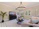 Bright living room with a decorative chandelier, tile floors, and large windows at 1920 Cherry Ne St, St Petersburg, FL 33704