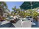 Outdoor deck with hammock, lounge seating and a green umbrella at 1920 Cherry Ne St, St Petersburg, FL 33704