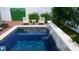 Sparkling pool featuring a waterfall feature, complemented by a tiled deck, plants, and outdoor seating at 1920 Cherry Ne St, St Petersburg, FL 33704