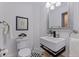 Stylish powder room featuring modern sink, patterned floor, and elegant fixtures at 1920 Cherry Ne St, St Petersburg, FL 33704