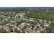 Wide aerial view of the residential neighborhood, showcasing mature trees, proximity to water, and overall community layout at 2254 Springrain Dr, Clearwater, FL 33763